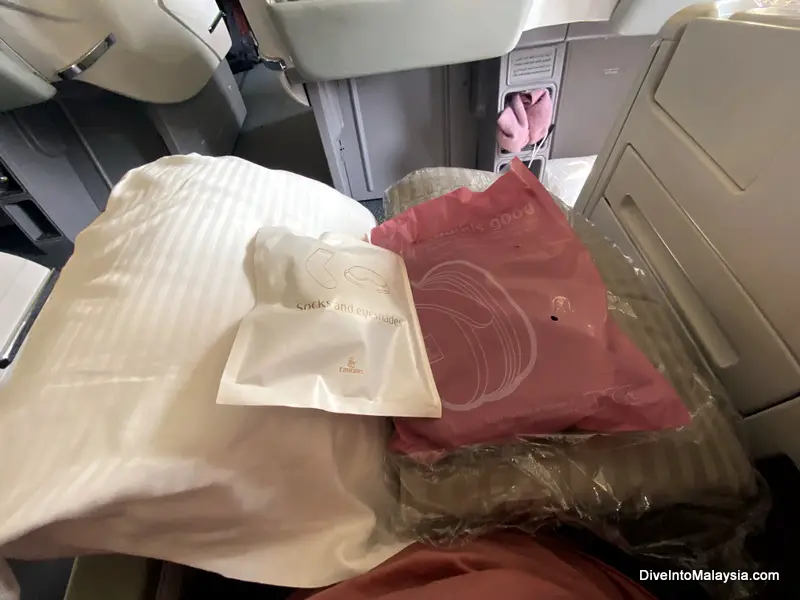 Emirates business class Blanket, pillow, headphones, eye mask and socks waiting at my seat
